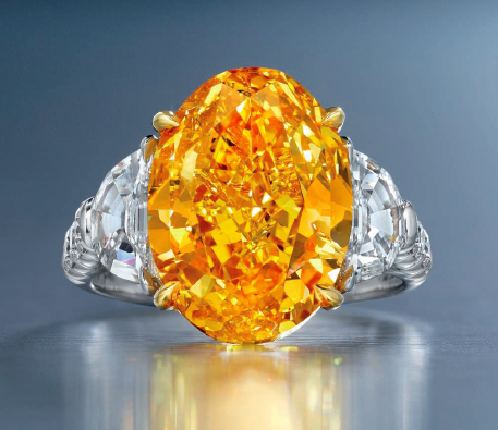 6.94 carat Fancy Vivid Yellowish Orange oval shaped diamond ring
